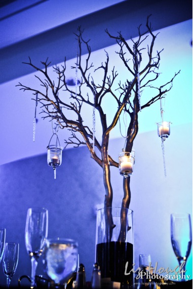 Below is a silver painted faux Manzanita branch centerpiece with hanging 